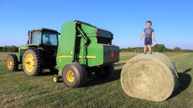 'Working on the farm with tractors | Baling hay for kids | Round baler'