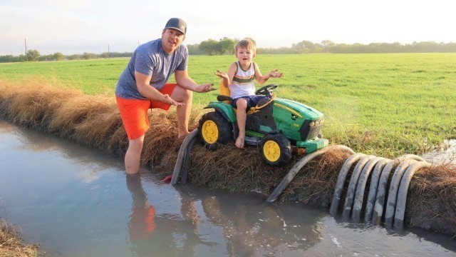 'Playing in the mud and watering hay with tractors | Tractors for kids in the mud'