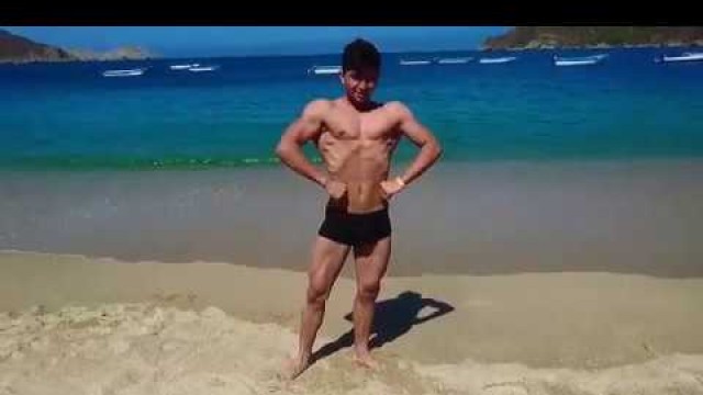 'Teen fitness model flexing muscle on the beach'